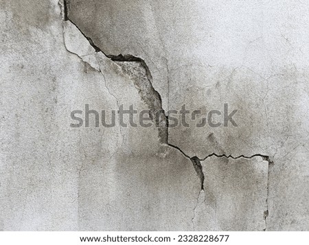 Close-up of cracked concrete wall. Cracked concrete should be fixed. Royalty-Free Stock Photo #2328228677