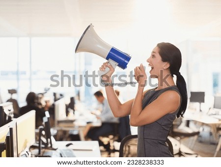 Exuberant businesswoman using megaphone in office Royalty-Free Stock Photo #2328238333