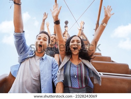 Portrait enthusiastic friends cheering on amusement park ride Royalty-Free Stock Photo #2328243069
