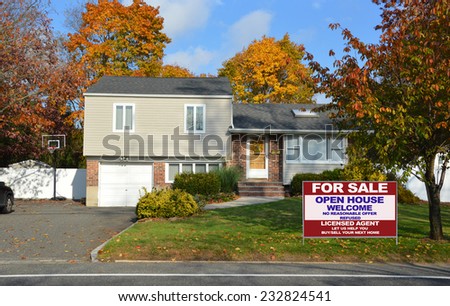 Real estate for sale open house welcome sign suburban high ranch home autumn day residential neighborhood blue sky clouds USA