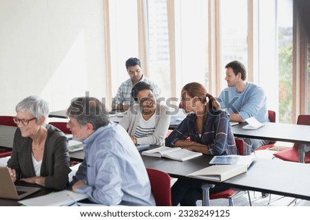 Adult education students working in pairs in classroom Royalty-Free Stock Photo #2328249125