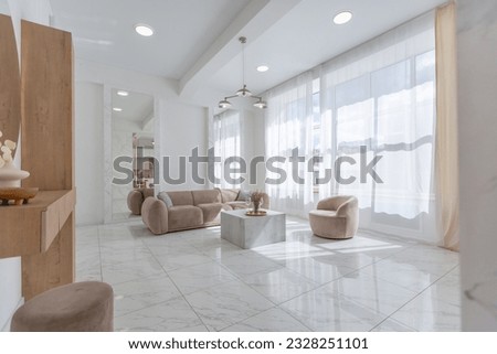 light luxury interior design of a modern apartment in a minimalist style with marble trim and huge windows. daylight inside the kitchen and living room Royalty-Free Stock Photo #2328251101