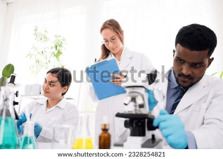 The diversity of scientists reports experimentation results to their colleagues in the research laboratory. Group of chemistry students working in the laboratory.