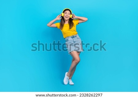 Full body photo of crazy positive lady hands touch headphones have good mood isolated on blue color background Royalty-Free Stock Photo #2328262297