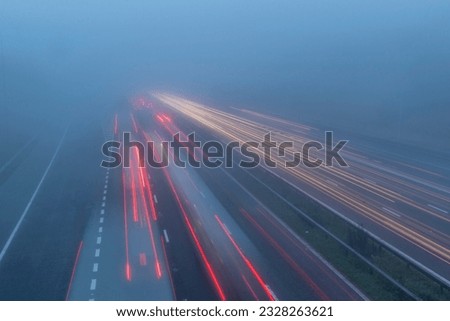 A Foggy day on the motorway with light trails.