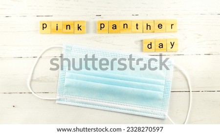 Pink Panther Day.words from wooden cubes with letters
