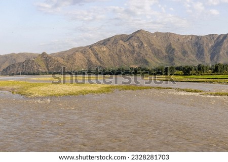 Muddy water in river after thunderstorm in the valley Royalty-Free Stock Photo #2328281703