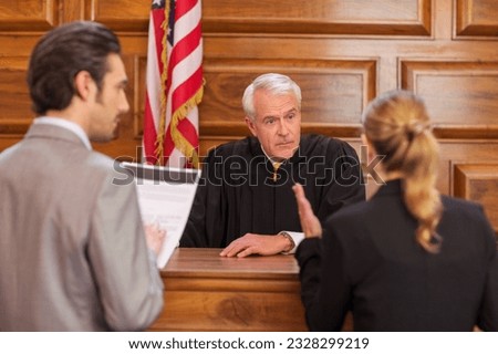 Lawyers pleading case to judge in court Royalty-Free Stock Photo #2328299219
