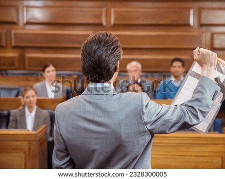 Lawyer showing documents to jury in court Royalty-Free Stock Photo #2328300005