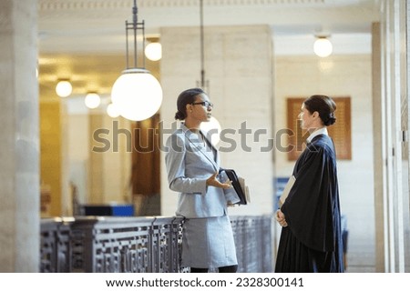 Judge and lawyer talking in courthouse Royalty-Free Stock Photo #2328300141