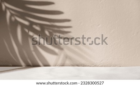 Minimal product placement background with palm shadow on plaster wall. Luxury summer architecture interior aesthetic. Creative product platform stage mockup. Royalty-Free Stock Photo #2328300527