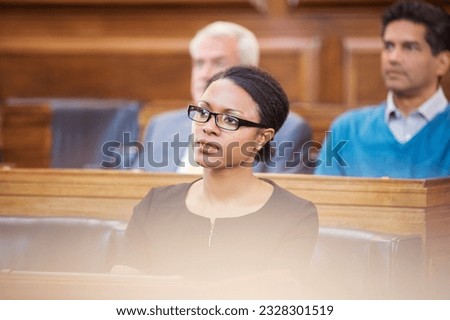 Woman observing legal trial in courtroom Royalty-Free Stock Photo #2328301519