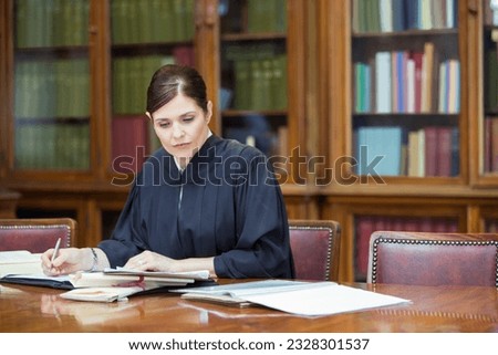 Judge doing research in chambers Royalty-Free Stock Photo #2328301537