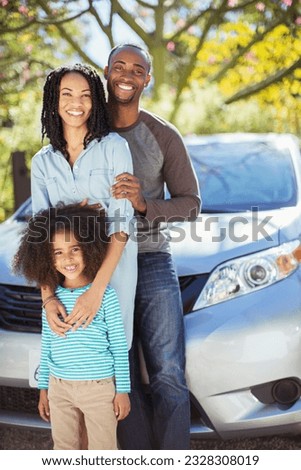 Portrait of happy family outside car