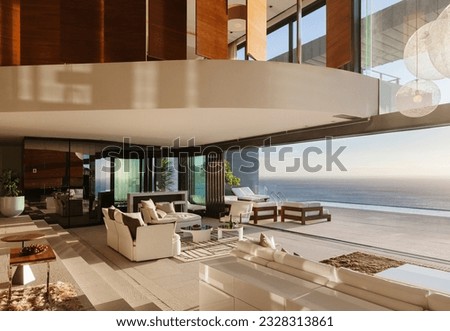 Living room in modern house overlooking ocean Royalty-Free Stock Photo #2328313861