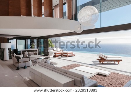 Living room in modern house overlooking ocean Royalty-Free Stock Photo #2328313883
