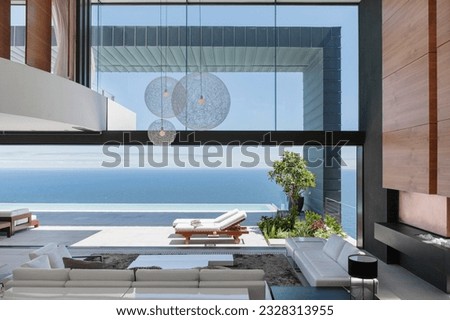 Modern luxury house overlooking ocean Royalty-Free Stock Photo #2328313955