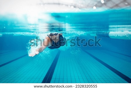 Competitive swimmer racing in pool Royalty-Free Stock Photo #2328320555