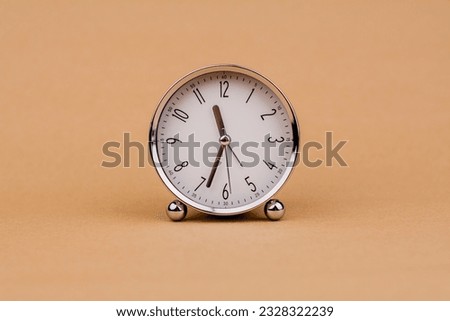 Alarm clock Beautiful modern clock lies on paper background time clock time standstill time off work working with time