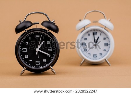 Alarm clock Beautiful modern clock lies on paper background time clock time standstill time off work working with time