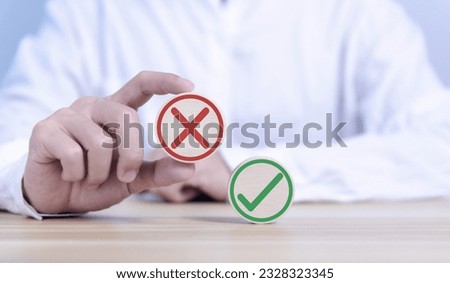 wood block showing right and wrong sign decision concept, vote and think yes or no Business options for difficult situations true and false symbol. select the wrong mark Royalty-Free Stock Photo #2328323345