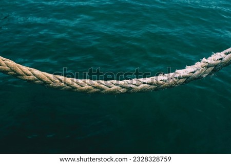 Ropes tied to the fence near the beach and near the sea