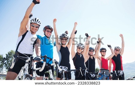 Happy cyclists cheering together outdoors Royalty-Free Stock Photo #2328338823