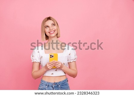Photo of cheerful charming lady blonde bob hair dreaming looking empty space use gadget fast internet adv isolated on pink color background