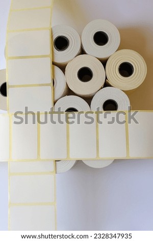 Rolls of white labels and printed barcodes isolated on white bac