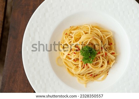 Peperoncino oil pasta on a plate Royalty-Free Stock Photo #2328350557