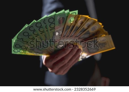 investment and financial saving concept, Money, Australian dollar (AUD) banknotes, in businessman hands, trading property invest stock market investors Royalty-Free Stock Photo #2328352669