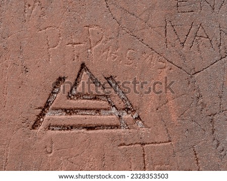 Carved signs and symbolism on a wall