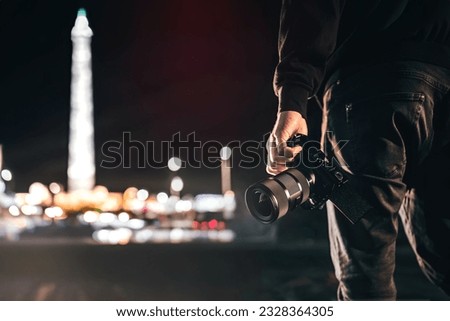 Silhouette of a Videomaker Holding a Camera, Immersed in Creative Adventure. The Art of Capture. Royalty-Free Stock Photo #2328364305