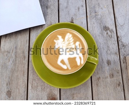 Cup Of Latte Art With A Picture Of A Winged Unicorn 