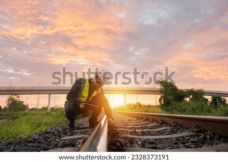 Asian engineer inspects trains Construction workers on the railway Engineer working on railway depot maintenance Royalty-Free Stock Photo #2328373191