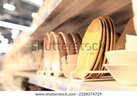 Crockery on a shelf in a store, selective focus. Plates on a blurred background. Shopping mall Royalty-Free Stock Photo #2328374729