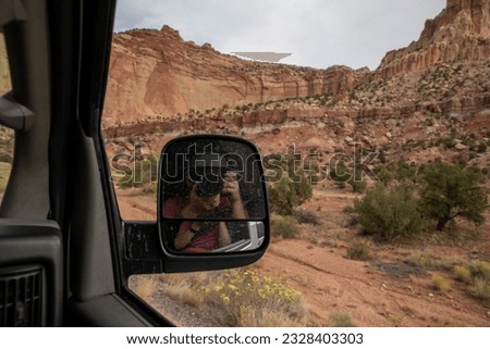 Photographer in side mirror photographing Capital Reef National Park