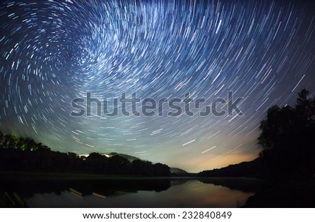 a beautiful night sky, the Milky Way, star trails and the trees Royalty-Free Stock Photo #232840849