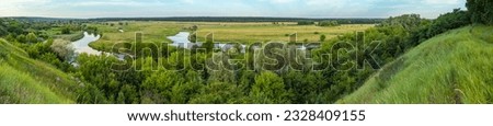 Landscape panorama of the picturesque valley of the Seversky Donets river with meadows and trees on a summer day