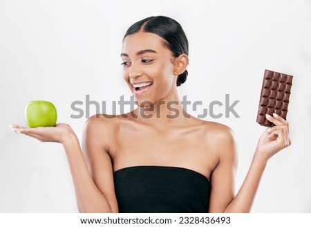 Apple, chocolate and happy woman for healthy food choice, sugar and skincare isolated on studio, white background. Dessert, green fruit and african person detox, vegan beauty or dermatology decision