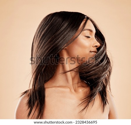 Woman, shaking hair and beauty with shine, growth and texture with natural cosmetics on studio background. Indian female model, satisfied with salon treatment and Brazilian, hairstyle and haircare