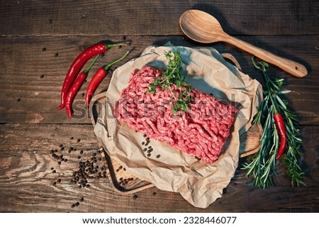 Raw meat in the form of minced meat on a paper surface. Raw food for cooking.