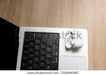 white wireless headphones on a laptop.