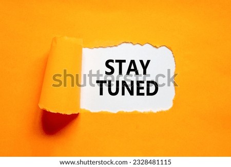 Stay tuned symbol. Concept words Stay tuned on beautiful white paper on a beautiful orange background. Business, support, motivation, psychological and stay tuned concept. Copy space. Royalty-Free Stock Photo #2328481115