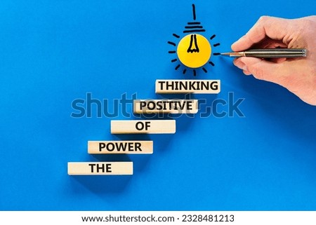 Positive thinking symbol. Concept words The power of positive thinking on wooden block. Beautiful blue background. Businessman hand. Business, motivational positive thinking concept. Copy space.