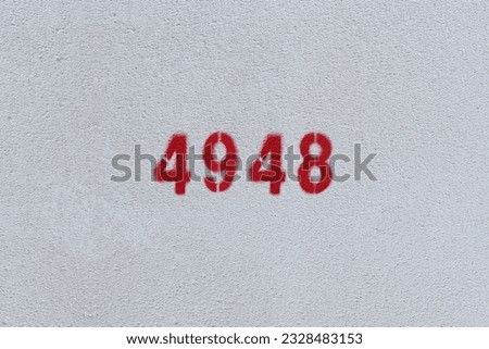 Red Number 4948 on the white wall. Spray paint.

