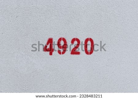 Red Number 4920 on the white wall. Spray paint.
