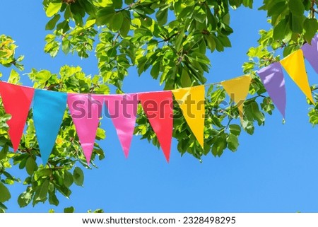 Colorful pennant string decoration against summer sky 