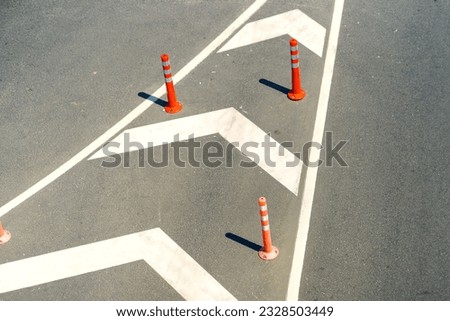 Top view: road markings with orange restrictive poles