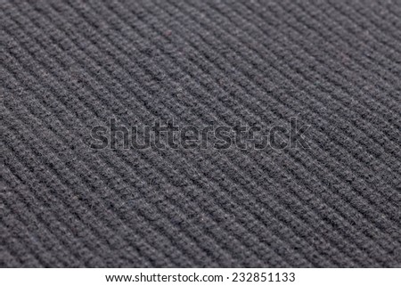 Detail of woven woolen design texture. Fabric black background